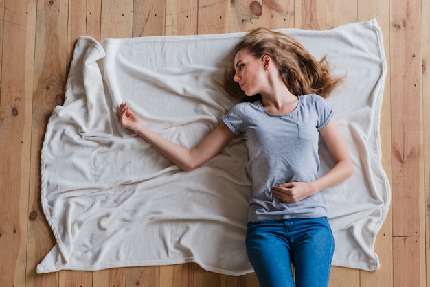 free-photo-woman-feeling-lonely-while-lying-alone-on-plaid