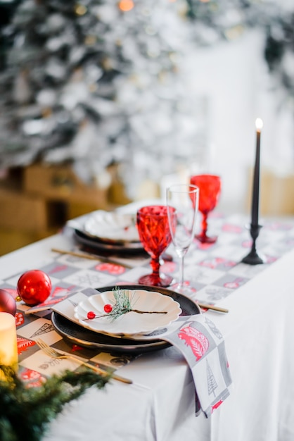 Premium Photo | Woman fire candles. christmas table setting in ...