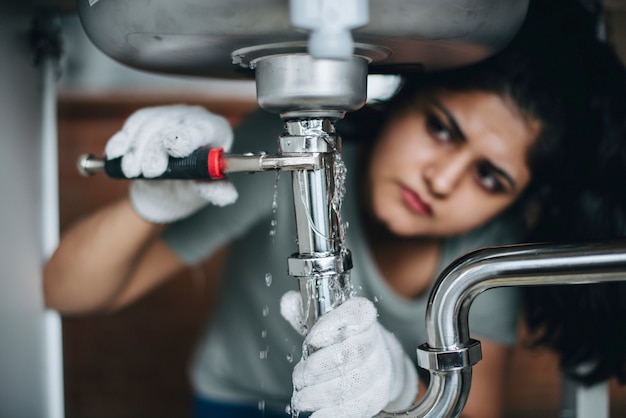 woman in kitchen by sink