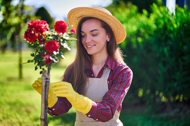 Premium Photo | Woman gardener in flowers garden