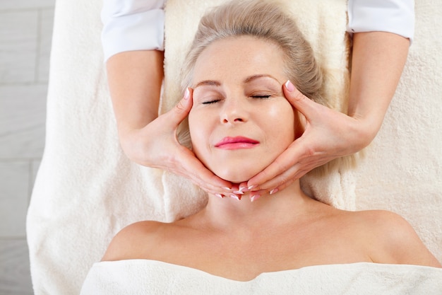 Premium Photo Woman Getting Massage For Face And Neck In Spa Salon