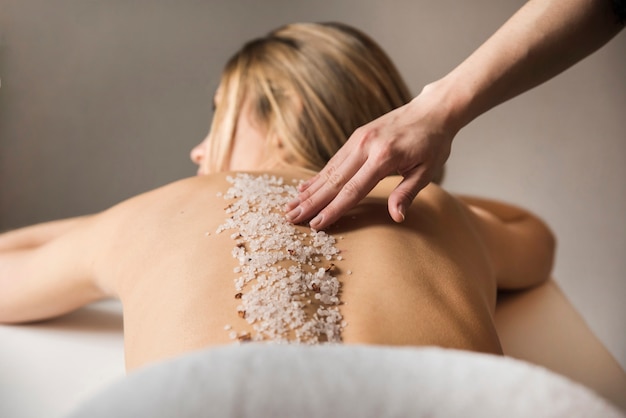 Woman getting massage with sea salt in spa Free Photo