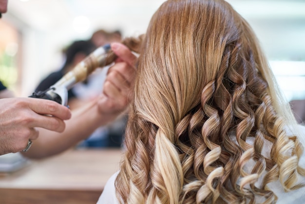 Premium Photo | Woman hairdresser making hairstyle in beauty salon