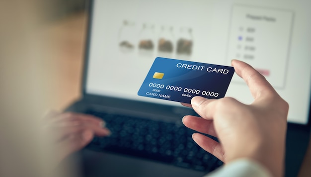 Premium Photo | Woman hand holding credit card and press laptop ...