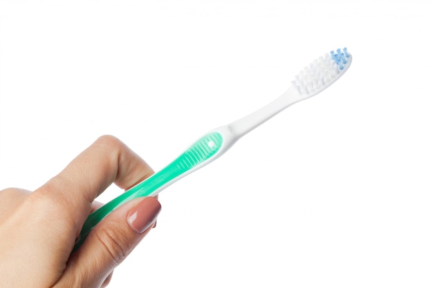 Premium Photo | Woman hand holding a toothbrush isolated on white