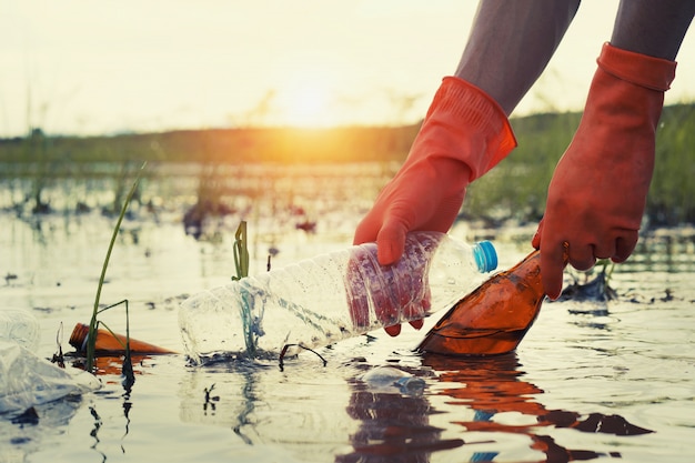 Premium Photo | Woman hand picking up garbage plastic for cleaning at ...