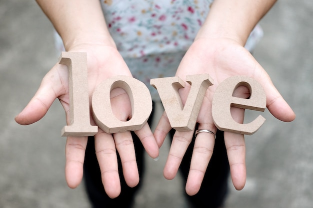 Premium Photo Woman Hands Holding Wooden Letters Word 0938