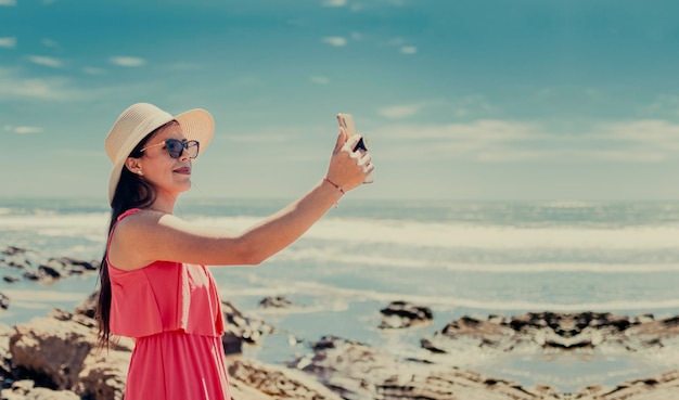 Premium Photo Woman In Hat Taking Photos In The Sea Girl Taking Vacation Photos Girl Taking