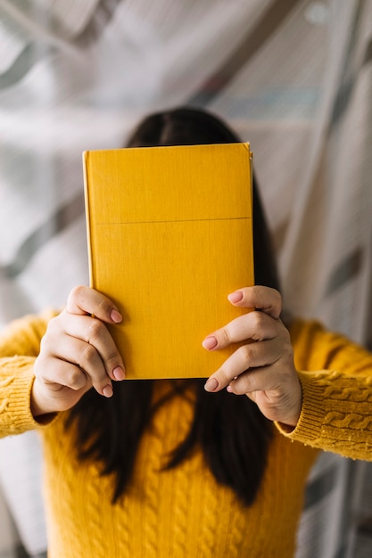 Free Photo Woman Hiding Face Behind Book