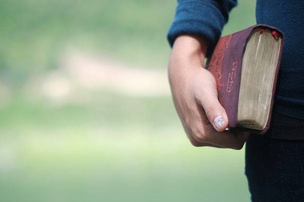 Woman holding a bible book. Photo | Premium Download