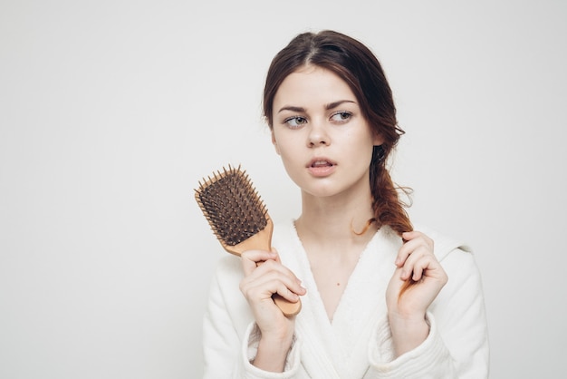 Premium Photo | Woman holding a comb in her hand and tangled hair ...