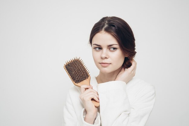 Premium Photo | Woman holding a comb in her hand and tangled hair ...