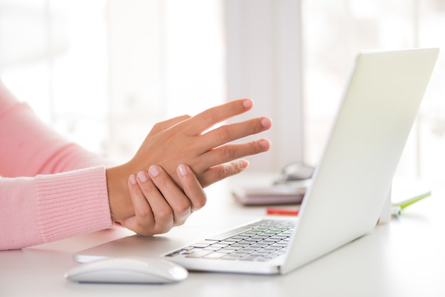 Woman holding her wrist pain from using computer. office syndrome. Premium Photo