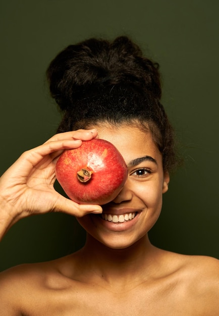 Premium Photo Woman Holding Pomegranate Fruit On Her Eye Posing