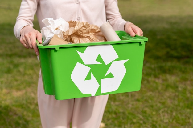 Woman holding recylcing basket Free Photo