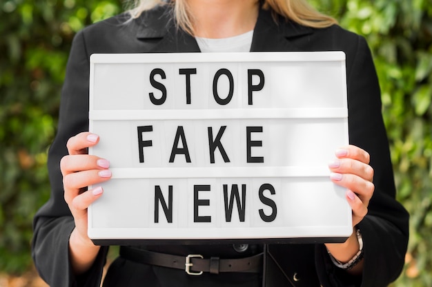 Free Photo Woman Holding Stop Fake News Sign 7153