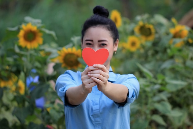 Premium Photo Woman Holding The Symbol Of Love In Front Of Her Face