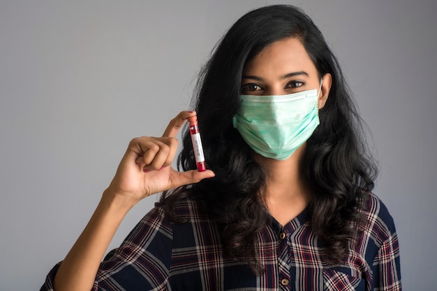 Premium Photo Woman Holding A Test Tube With Blood Sample For