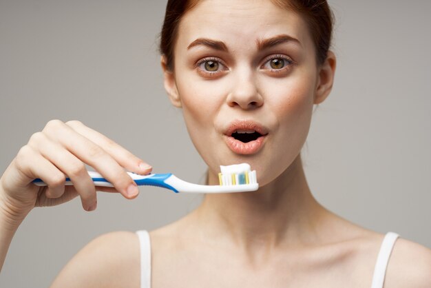 Premium Photo Woman Holding Toothbrush