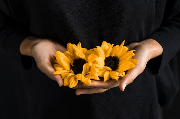 Free Photo | Woman holding yellow flowers in hands
