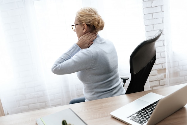 Premium Photo | Woman holds her hands to her neck.