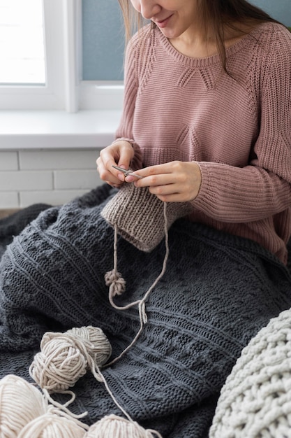 Free Photo | Woman at home knitting close up