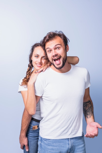 Woman hugging happy man from behind Free Photo