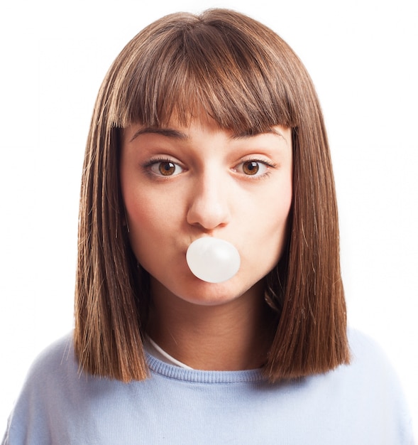 Woman inflating a chewing gum Photo | Free Download