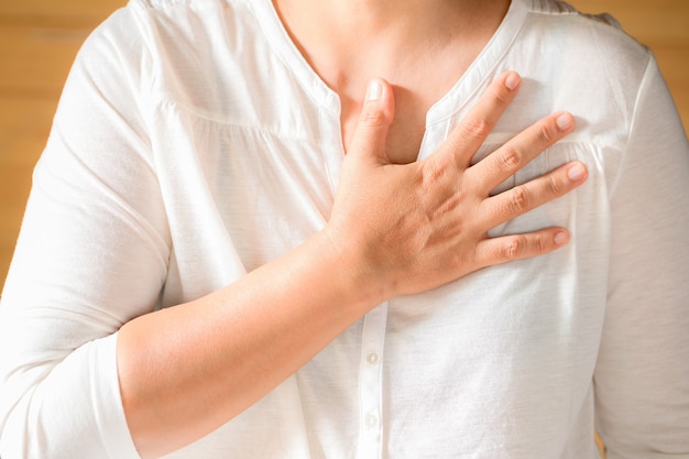 Woman is clutching her chest Free Photo