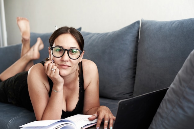 Premium Photo A Woman Is Laying On Sofa Surfing Computer