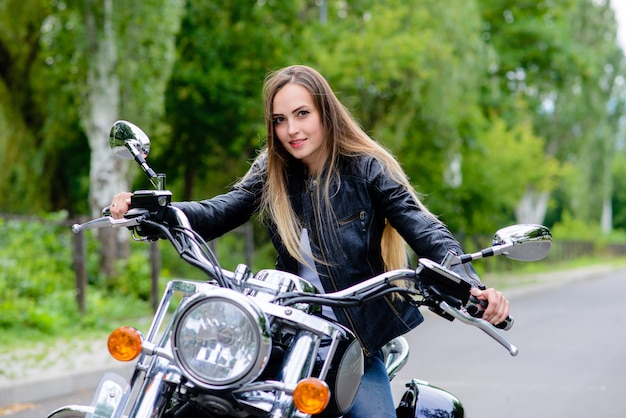 Premium Photo | A woman is sitting on a motorcycle and smiling.