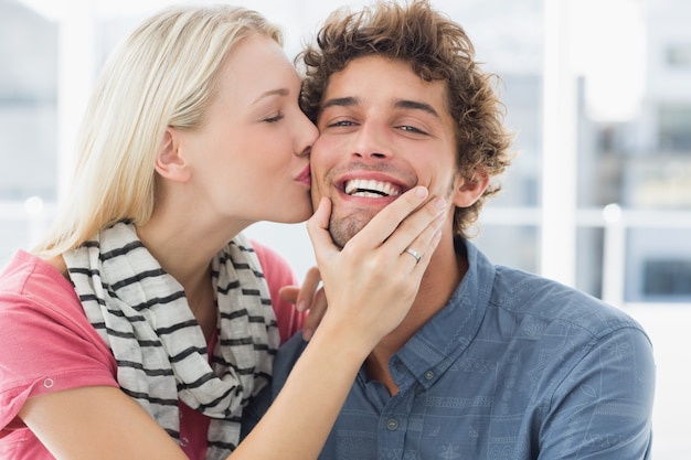 Premium Photo | Woman kissing man on his cheek