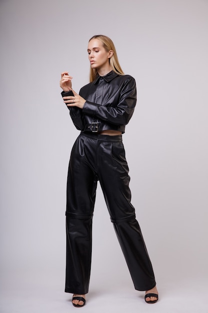 Premium Photo | Woman in leather suit pants jacket posing on white ...