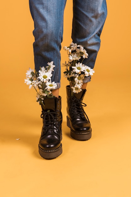 Woman legs with flowers in shoes