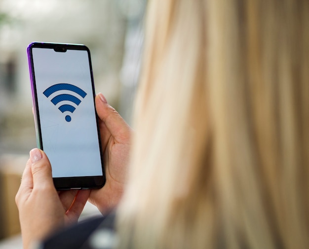 Free Photo Woman Looking At Phone Screen With Wifi Logo