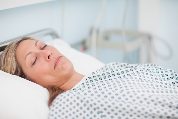 Premium Photo | Woman lying on a bed while closing her eyes