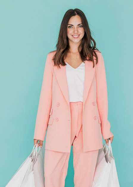 Woman in pink suit on blue background Free Photo