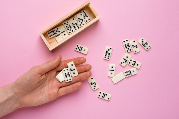 Premium Photo Woman Play Board Game Of Dominoes On Pink