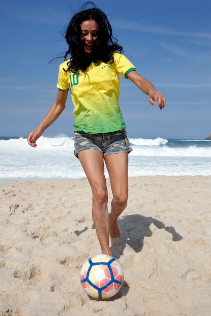 Premium Photo | Woman playing ball on the beach