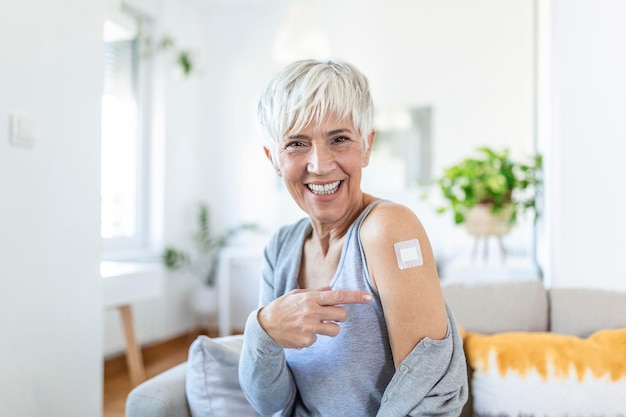 Premium Photo | Woman pointing at her arm with a bandage after