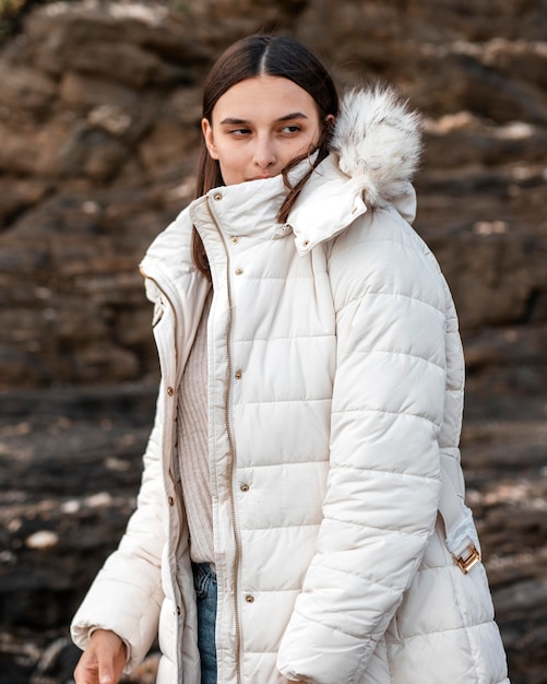 Free Photo | Woman posing at the beach with winter jacket