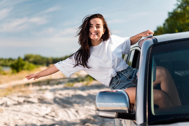 Premium Photo | Woman posing while leaning on car window