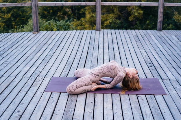 Free Photo | A woman practices yoga at the morning in a terrace on a ...