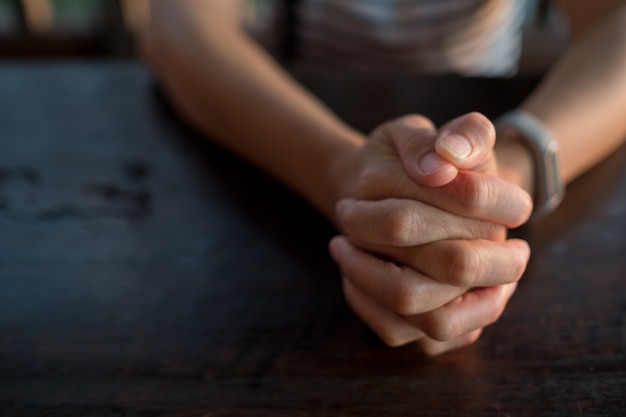 Woman praying in morning, hands folded in prayer | Premium ...