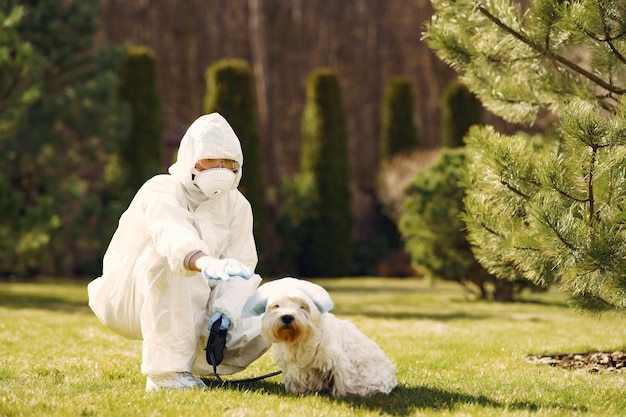 Free Photo | Woman in a protective suit walking with a dog