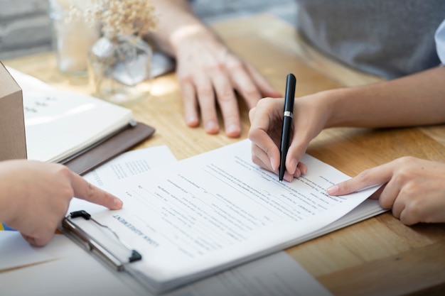 Woman Putting Signature on Loan Contract