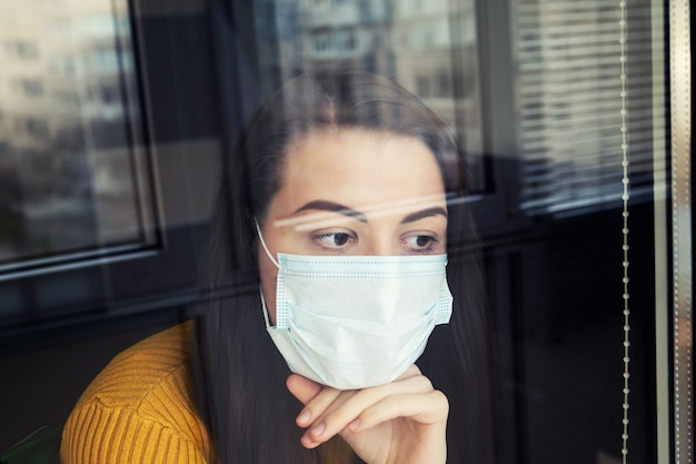 Woman in quarantine wearing protective mask. Free Photo