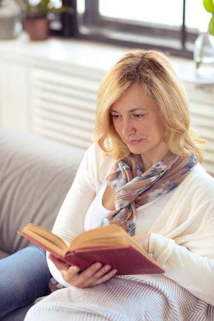 Free Photo | Woman reading on sofa