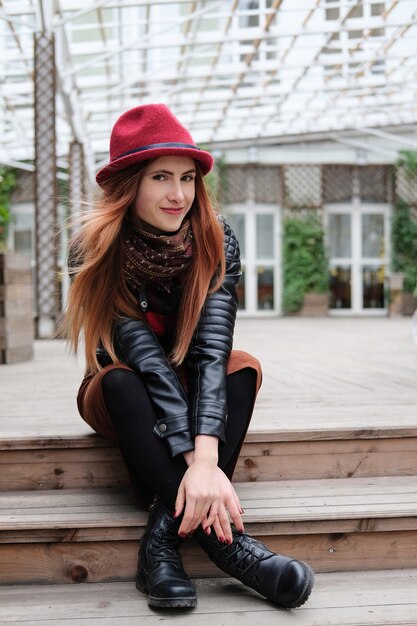 Premium Photo | Woman in a red bowler hat with long hair smiling and ...