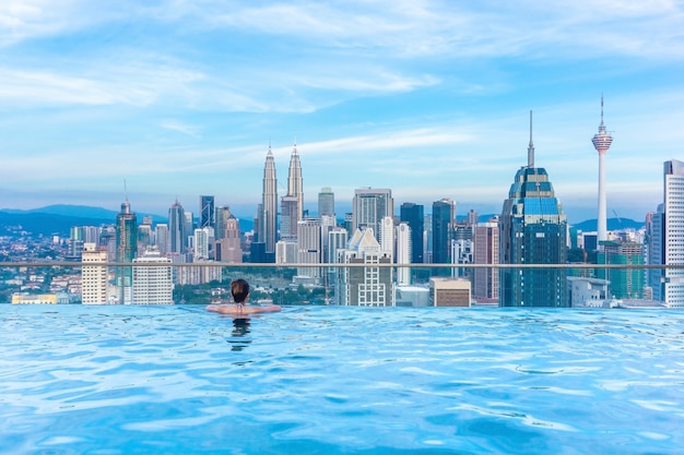 Premium Photo Woman Relaxing In Infinity Swimming Pool Roof Top